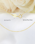 Close-up of 14k gold-filled cable chain showing the metal quality stamp and spring clasp closure on a sapphire lotus necklace