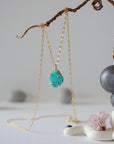 14k gold vermeil turquoise necklace close up showing claw setting and raw stone detail