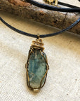 Handcrafted green kyanite necklace for men, front view – artisan antique bronze and gold copper wire wrapping, alternative May birthstone, natural crystal pendant.