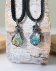 Two raw opal pendants for men – unique differences in Ethiopian fire opal crystals, wire-wrapped, black leather cord.