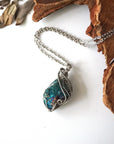 Handcrafted peacock ore necklace for women, laying flat on white gold chain – artisan wire wrapped, Capricorn and Cancer birthstone, natural crystal pendant.