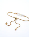 Gold plated brass slider closure on adjustable clear quartz bracelet showing easy fit mechanism - handcrafted birthstone jewelry