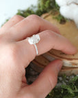 Adjustable raw rainbow moonstone ring on hand in 925 sterling silver setting, natural moonstone flash, June birthstone ring for women.
