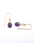 Closeup showing details of amethyst drop earrings, faceted amethyst stone, 14k gold filled setting