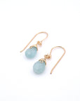 Angled view of aquamarine drop earrings, showing detailed wire wrapping and faceted aquamarine, 14k gold filled