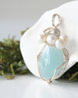 Side angle of handmade aquamarine and freshwater pearl pendant necklace, silver wire wrapped jewelry