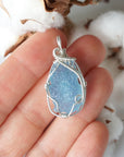 Raw aquamarine necklace in hand for size reference, artisan wire wrapped, 925 sterling silver