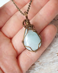 Genuine aquamarine necklace shown in hand for size reference, handcrafted artisan jewelry by Designs by Nature Gems.