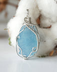 Close-up of raw aquamarine pendant front, artisan wire wrapped in 925 sterling silver