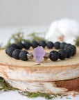 Detailed view of unisex stretch bracelet with 8mm black lava beads, raw amethyst (February birthstone) and pyrite accents