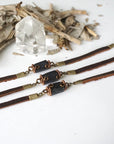 Three black tourmaline leather bracelets side by side, showing how each natural stone differs