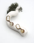 Bird’s eye view of citrine drop earrings laying flat on a display, showing detailed wire wrapping and gemstone color.