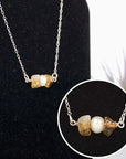 Close up of citrine and pearl bar pendant showing natural crystal and freshwater pearl wire wrapped in sterling silver 925 - handmade horizontal bar necklace detail