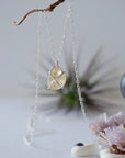 Close up back view of citrine pendant showing sterling silver 925 wire wrapping detail and craftsmanship - huggie necklace back side artisan jewelry