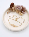 Handmade citrine bracelet displayed on ceramic tray showing natural golden crystals and gold chain - November birthstone gift for her