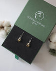Citrine sterling silver drop earrings in branded Designs by Nature Gems jewelry box, showcasing handcrafted faceted citrine and sterling silver wire wrapping