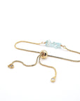 Gold plated brass slider closure on adjustable aquamarine bracelet showing easy fit mechanism - handcrafted birthstone jewelry