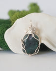 Back detail of silver wire wrapped emerald and freshwater pearl pendant necklace, handcrafted gemstone jewelry