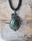 Emerald necklace for men with natural polished-raw emerald in antiqued sterling silver wire wrapping, detailed front view