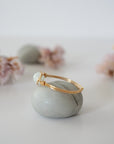 Side angle of gold aquamarine ring, artisan wire wrapped, minimalist design