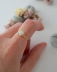 Minimalist gold aquamarine ring on female model's hand, handcrafted, Designs by Nature Gems