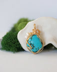 Back view of gold plated copper wire wrapped turquoise pearl pendant showing handmade wire technique