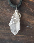 Back angle detail of raw Herkimer diamond pendant for men with intricate artisan wire wrapping in 925 sterling silver.