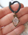 Raw Herkimer diamond pendant for men shown in hand for size reference, handmade in antique bronze copper.