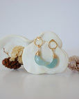 Front angle look at Lux Aquamarine Moon Open Circle Stud Earrings on jewelry display, faceted natural aquamarine, gold filled, handmade.