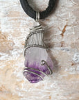 Back side angle of men’s raw amethyst pendant wire wrapped in white gold plated copper on black leather cord