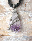 Detailed front view of men’s raw amethyst pendant wire wrapped in white gold plated copper on black leather cord