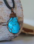 Mens raw turquoise necklace with bronze copper wire wrapping right side detail