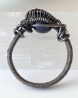 Detail of approximately 4mm men's sapphire ring band with antiqued 925 sterling silver wire-wrapped artisan finish