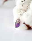 Left side angle of minimalist amethyst necklace for women, silver plated copper wire wrapped raw amethyst pendant