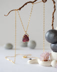 Full view of minimalist garnet necklace for women with raw garnet stone in 14k gold vermeil claw setting on 14k gold filled chain