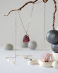 Full view of minimalist garnet necklace with raw garnet stone in 925 sterling silver claw setting on silver chain