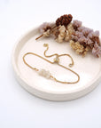 Handmade moonstone bracelet displayed on ceramic tray showing natural iridescent crystals and gold chain - June birthstone gift for her