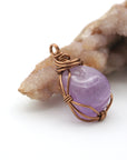 Side angle detail of natural amethyst wire wrapped pendant in antique bronze copper, handmade necklace