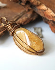 Side angle of natural citrine pendant showing crystal dimension and wire wrap detail - antique bronze copper handmade unisex necklace for women men profile view