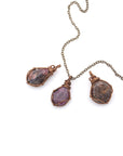 Three natural raw ruby pendants side by side showing unique variation in size, shape, and colour — each one of a kind by nature
