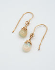 Angled look at opal drop earrings, artisan wire wrapping in 14k gold filled, October birthstone