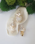 Three silver wire wrapped opal and freshwater pearl pendants showing natural stone variation, artisan jewelry for women