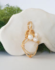 Side angle detail of opal and freshwater pearl pendant, gold wire wrapped, ethical artisan necklace