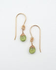 Detailed front view of peridot drop earrings, genuine faceted peridot with minimalist 14k gold filled wire wrapping, Designs by Nature Gems