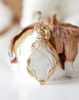 Back angle view of rainbow moonstone pendant showing detailed handcrafted 14k gold filled wire wrapping