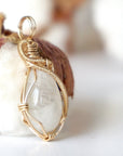 Right angle view of rainbow moonstone pendant showing handcrafted 14k gold filled wire wrapping detail