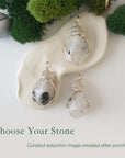 Three rainbow moonstone pendants showing natural variation in size shape and colour in handmade artisan jewelry