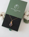 Raw amethyst necklace in 14k gold filled displayed in branded Designs by Nature Gems jewelry box. Artisan February birthstone gift for women.