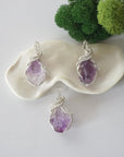 Three raw amethyst necklaces showing natural purple crystal variations in handmade wire wrapped pendants
