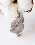 Detailed front view of raw amethyst pendant, natural amethyst crystal wrapped in sterling silver artisan wire